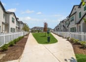 Thumbnail 32 of 40 - an empty sidewalk in front of a row of houses