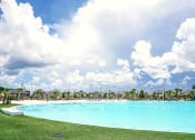 Thumbnail 23 of 40 - a large lagoon with houses in the background and a grassy area in the foreground