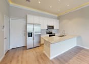 Thumbnail 29 of 40 - a kitchen with white cabinets and a counter top and a refrigerator