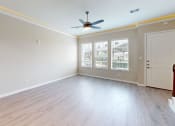Thumbnail 8 of 40 - an empty living room with white walls and a ceiling fan
