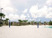 Thumbnail 22 of 40 - a volleyball court on a sandy beach with palm trees in the background