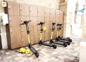 Thumbnail 26 of 40 - a row of scooters parked next to lockers in a locker room