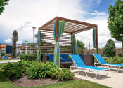 Thumbnail 27 of 40 - a gazebo with blue lounge chairs and curtains