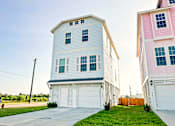 Thumbnail 19 of 19 - a white and pink house on the side of a street
