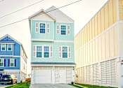 Thumbnail 13 of 19 - a blue house in front of a row of houses