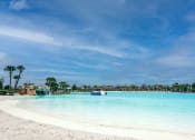 Thumbnail 24 of 40 - a large body of water with a sandy beach