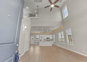 Thumbnail 2 of 17 - A spacious room with a ceiling fan and a window.