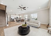 Thumbnail 9 of 17 - a living room with a couch and a ceiling fan