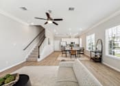Thumbnail 11 of 17 - a living room with a couch and a ceiling fan