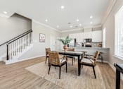 Thumbnail 6 of 17 - a dining room with a table and chairs
