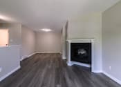 Thumbnail 16 of 20 - a living room with a fireplace and hardwood floors