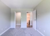 Thumbnail 13 of 20 - a bedroom with gray walls and carpet
