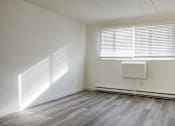 Thumbnail 3 of 12 - A room with a window and a radiator on the wall.