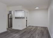 Thumbnail 2 of 12 - A kitchen area with a refrigerator, cabinets, and a countertop.
