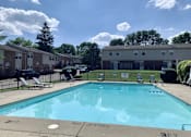 Thumbnail 7 of 14 - A pool surrounded by apartment buildings and a "No Diving" sign.