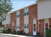 Thumbnail 9 of 14 - A row of townhouses with brick and siding exteriors.