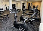 Thumbnail 11 of 16 - A gym with a variety of cardio equipment including treadmills and stationary bikes.