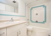 Thumbnail 10 of 21 - a bathroom with a sink toilet and a bath tub