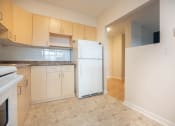 Thumbnail 7 of 21 - a kitchen with a white refrigerator and white cabinets