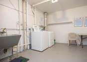 Thumbnail 13 of 21 - a room with two refrigerators and a table and a chair