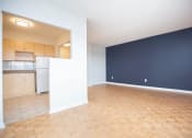 Thumbnail 1 of 21 - an empty living room and kitchen with a wood floor