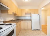 Thumbnail 4 of 21 - a kitchen with a stove and a refrigerator