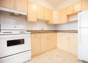 Thumbnail 3 of 21 - a kitchen with white appliances and ivory cabinets