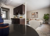 Thumbnail 15 of 15 - a kitchen and living room with a table and chairs