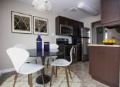 Thumbnail 14 of 15 - a kitchen and dining room with a table and chairs