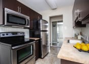 Thumbnail 6 of 15 - a kitchen with stainless steel appliances and a sink