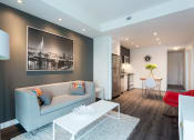 Thumbnail 10 of 18 - a living room with a gray couch and a white coffee table