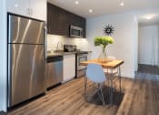 Thumbnail 11 of 18 - a kitchen and dining area in a 555 waverly unit