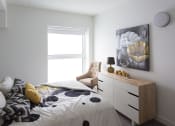 Thumbnail 12 of 18 - a bedroom with a bed and a dresser