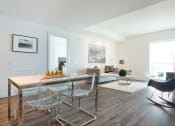 Thumbnail 8 of 18 - a living room with white walls and hardwood floors