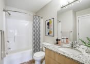 Thumbnail 11 of 31 - a bathroom with a sink and a toilet and a shower