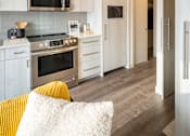 Thumbnail 22 of 30 - A modern kitchen with a stove, oven, and microwave.