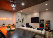 Thumbnail 8 of 30 - A modern living room with a wooden ceiling and a neon sign that says "your best friend".
