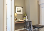 Thumbnail 20 of 31 - a desk and a chair in a room with a door