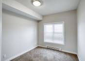 Thumbnail 25 of 31 - an empty room with a window and carpet