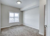 Thumbnail 24 of 31 - an empty room with a window and carpet