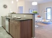 Thumbnail 7 of 31 - a kitchen with an island in the middle of a living room