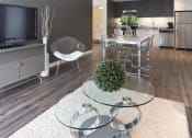 Thumbnail 5 of 18 - a living room and kitchen with a glass table