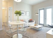 Thumbnail 22 of 31 - a living room with a table and chairs