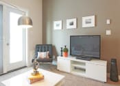 Thumbnail 21 of 31 - a living room with a tv and a table