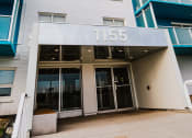Thumbnail 20 of 21 - a tall building with a sign that reads 1155 on the front of it
