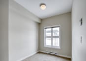 Thumbnail 18 of 31 - an empty room with a window and carpet