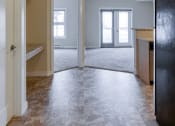 Thumbnail 14 of 31 - an empty living room and kitchen with the door open