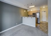 Thumbnail 9 of 31 - an empty living room and kitchen with a stainless steel refrigerator