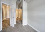 Thumbnail 19 of 31 - a bedroom with a closet and a mirror
