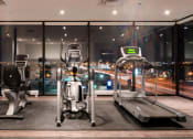 Thumbnail 17 of 18 - a gym with a view of the city at night